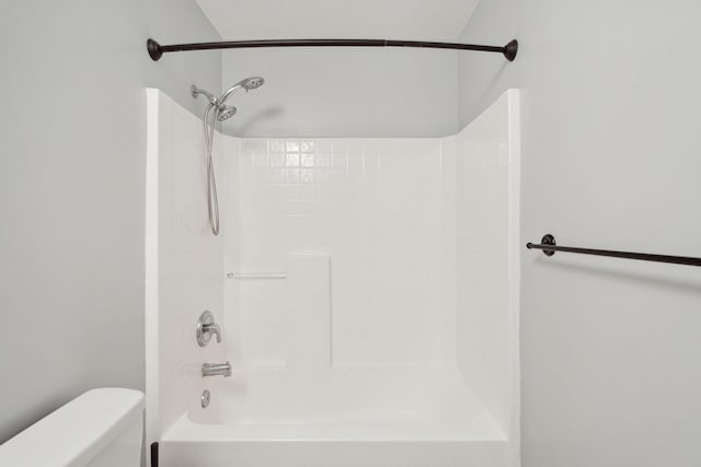 bathroom with shower / bathing tub combination and toilet