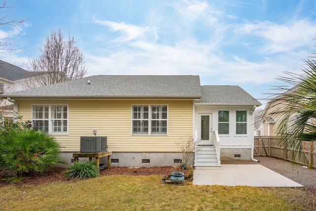 back of property with a patio, central AC unit, and a lawn