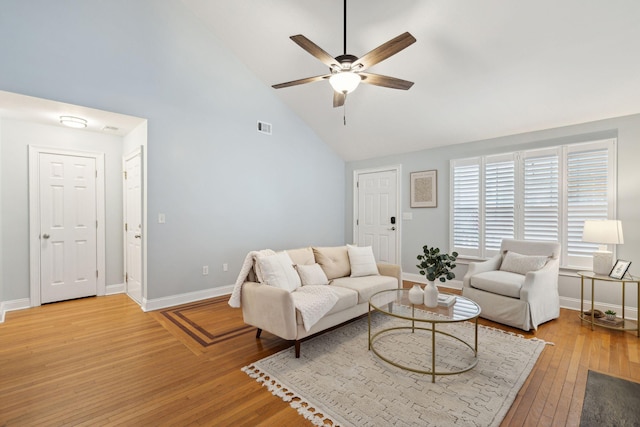 living room with ceiling fan, high vaulted ceiling, and light wood-type flooring