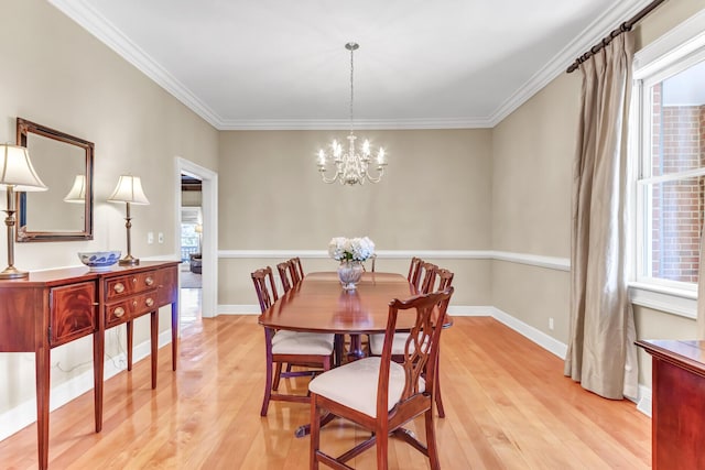 dining space with a chandelier, baseboards, crown molding, and light wood-style floors