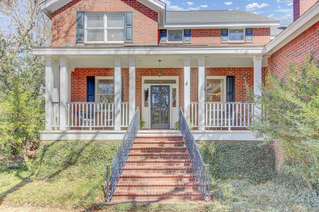 entrance to property with brick siding and covered porch