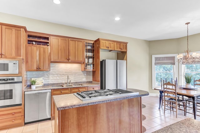 kitchen featuring light tile patterned flooring, decorative backsplash, stainless steel appliances, and a sink