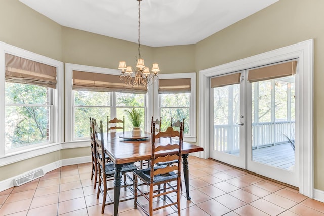 dining area with light tile patterned floors, visible vents, french doors, and an inviting chandelier