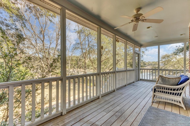 unfurnished sunroom featuring a ceiling fan