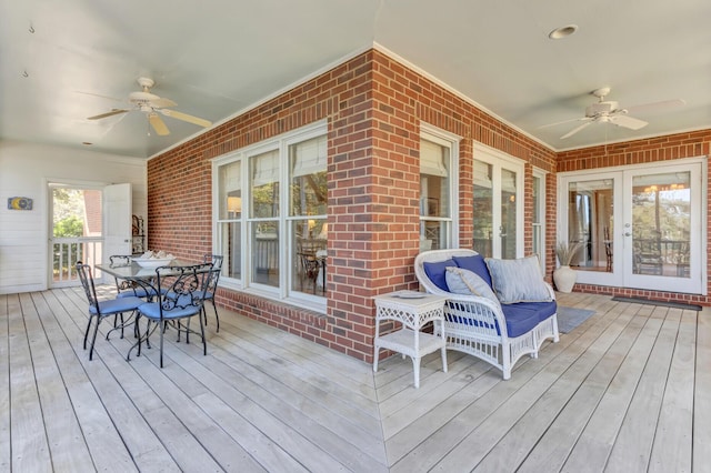 wooden terrace featuring french doors, outdoor dining area, and ceiling fan