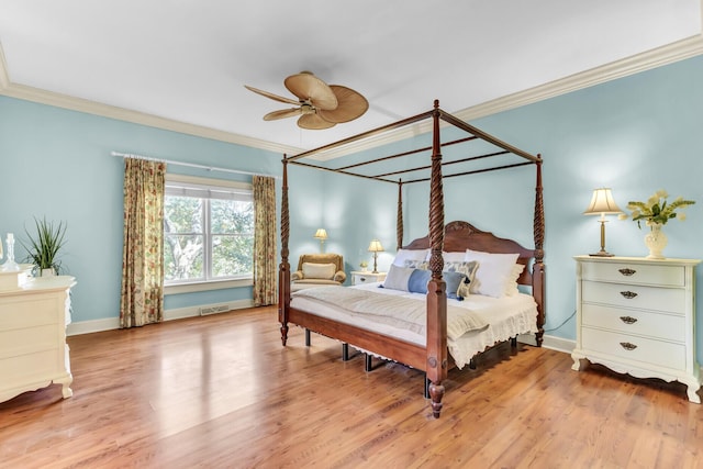 bedroom with ornamental molding, baseboards, and wood finished floors