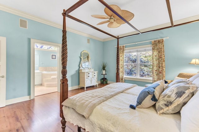 bedroom featuring visible vents, crown molding, baseboards, and wood finished floors