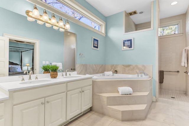 bathroom featuring ensuite bath, a wealth of natural light, and a sink