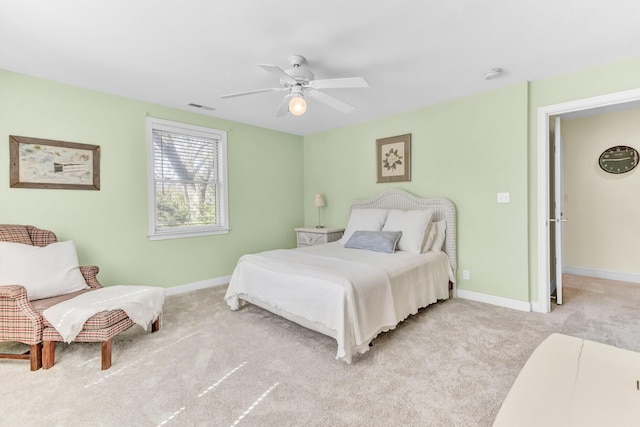 bedroom featuring light carpet, visible vents, a ceiling fan, and baseboards