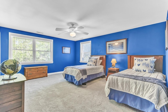 bedroom featuring ceiling fan, baseboards, and carpet