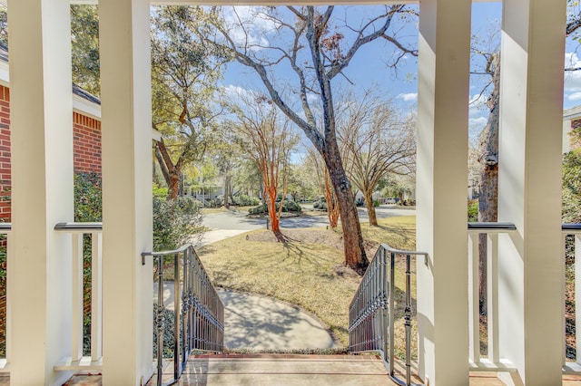 view of yard with a porch and a gate