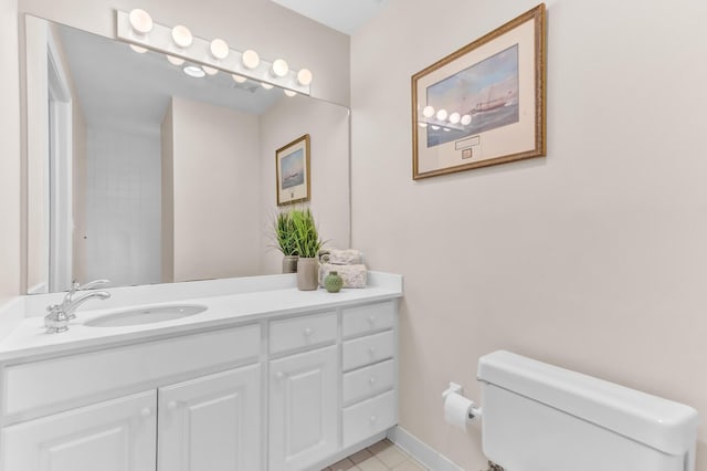 bathroom featuring vanity, toilet, and baseboards