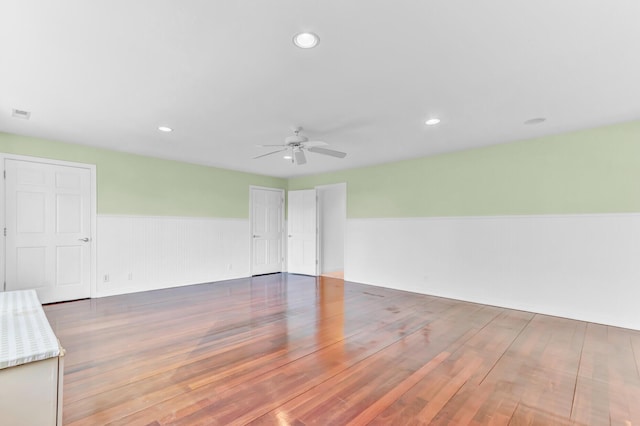 unfurnished room featuring recessed lighting, a wainscoted wall, wood finished floors, and a ceiling fan