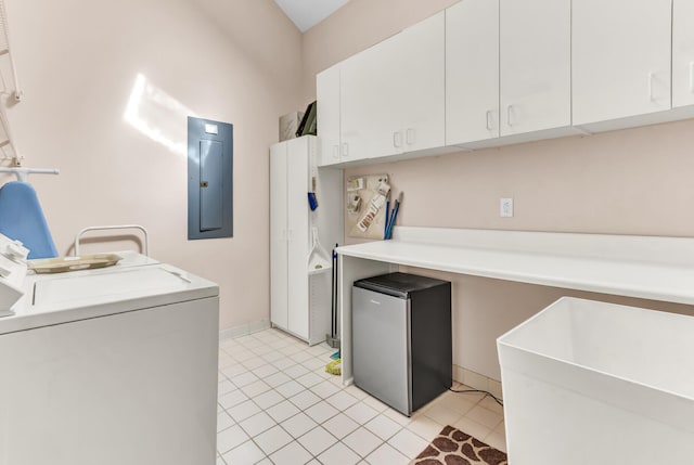 clothes washing area with light tile patterned floors, baseboards, washer / dryer, electric panel, and cabinet space