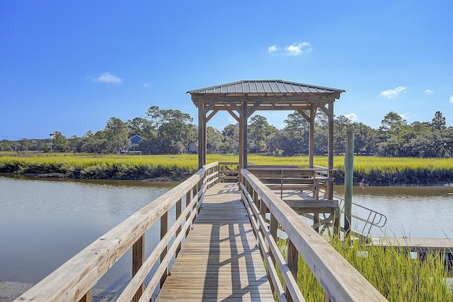 view of dock with a gazebo and a water view