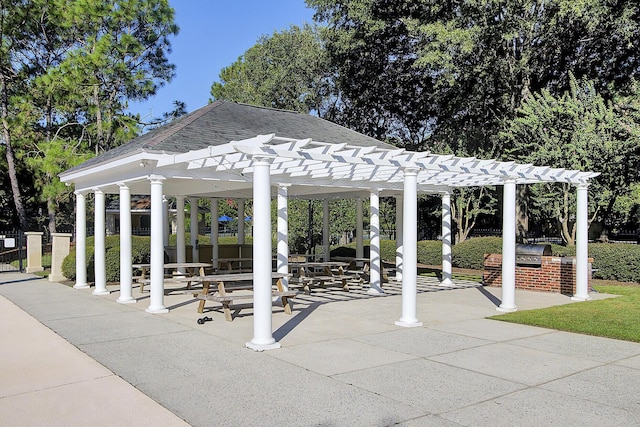 surrounding community featuring area for grilling, a pergola, and a patio