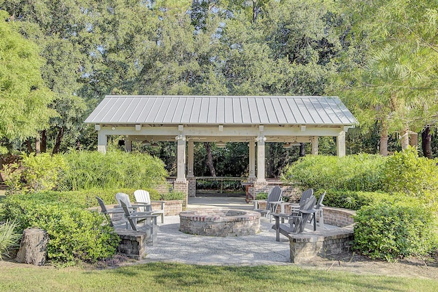 view of home's community featuring a gazebo, a patio area, and a fire pit