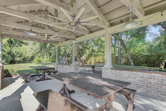 view of patio featuring outdoor dining area and a ceiling fan