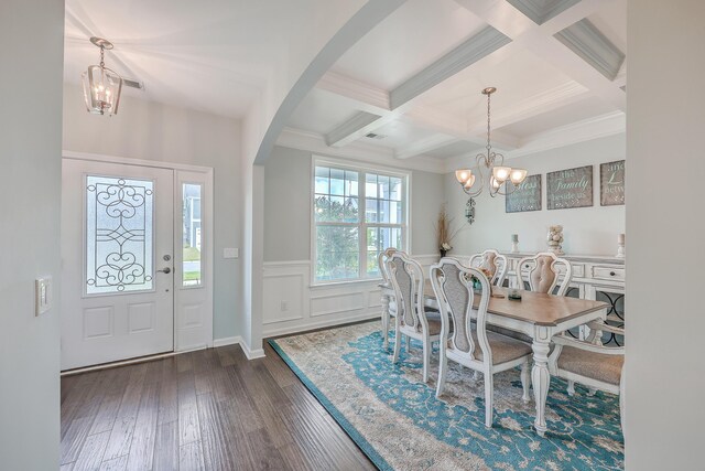 dining room featuring dark hardwood / wood-style flooring, an inviting chandelier, and coffered ceiling