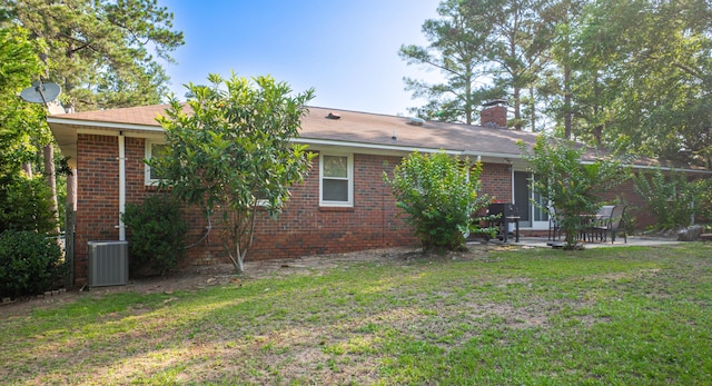 6427 Quimby Rd, Dalzell, SC 29040 - back of property with central AC, a patio area, a lawn, and brick siding