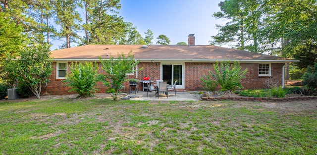 6427 Quimby Rd, Dalzell, SC 29040 - back of property with a chimney, a yard, a patio area, and brick siding