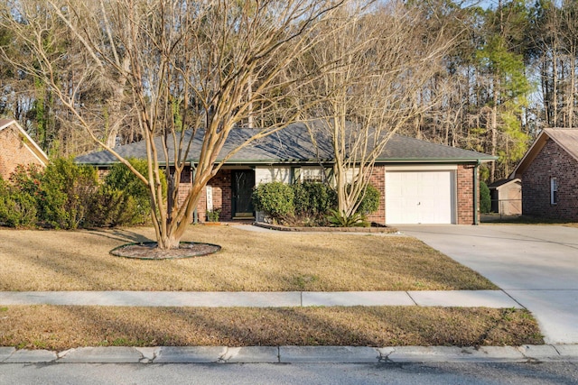 ranch-style home featuring driveway, brick siding, an attached garage, and a front lawn