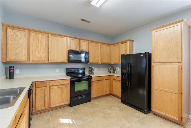 kitchen featuring black appliances, sink, and light brown cabinets