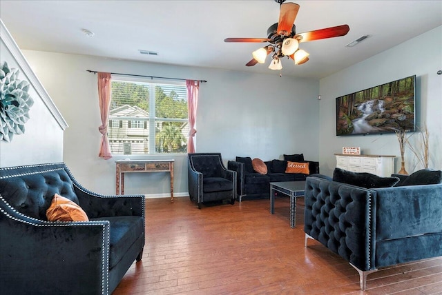 living room featuring ceiling fan and hardwood / wood-style flooring