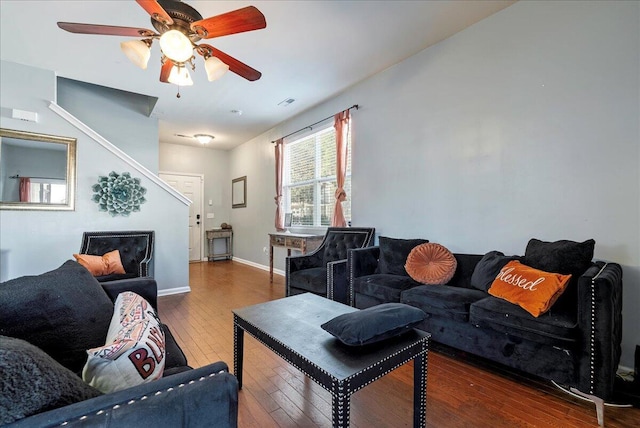 living room with ceiling fan and dark hardwood / wood-style floors