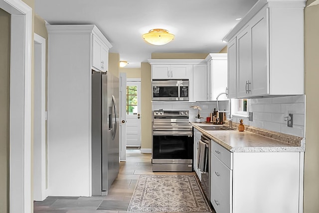 49 Crosscreek Dr, Charleston, SC 29412 - kitchen with stainless steel appliances, backsplash, light countertops, white cabinets, and a sink
