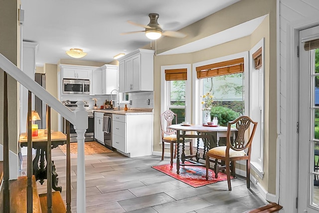 49 Crosscreek Dr, Charleston, SC 29412 - kitchen with appliances with stainless steel finishes, light countertops, ceiling fan, white cabinets, and a sink