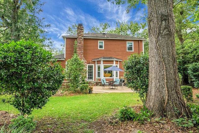 49 Crosscreek Dr, Charleston, SC 29412 - rear view of house with a chimney, a patio, a lawn, and roof with shingles