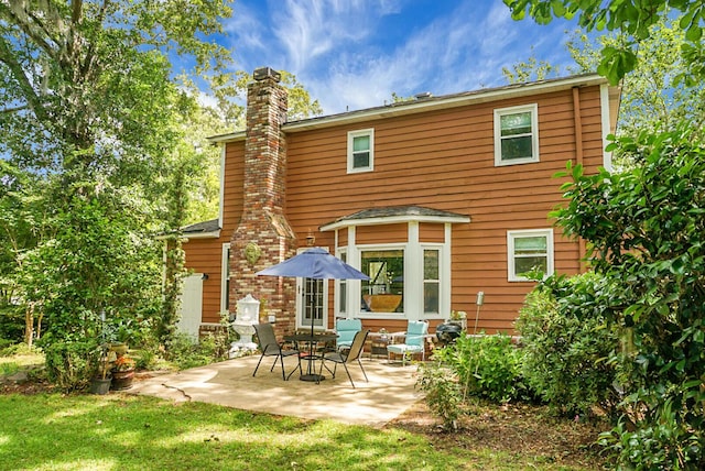 49 Crosscreek Dr, Charleston, SC 29412 - back of house featuring a chimney, a patio, and a lawn