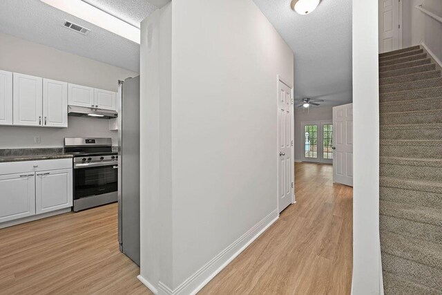 4591 Great Oak Dr, North Charleston, SC 29418 - corridor featuring visible vents, a textured ceiling, light wood finished floors, and stairway