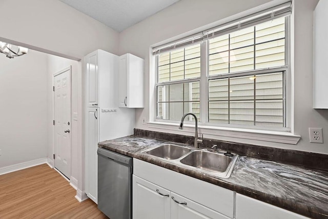 4591 Great Oak Dr, North Charleston, SC 29418 - kitchen with a sink, dark countertops, stainless steel dishwasher, and white cabinetry