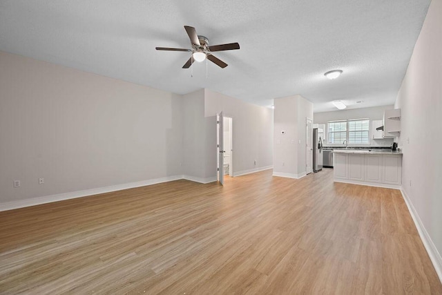 4591 Great Oak Dr, North Charleston, SC 29418 - unfurnished living room featuring baseboards, a sink, light wood-style flooring, and ceiling fan