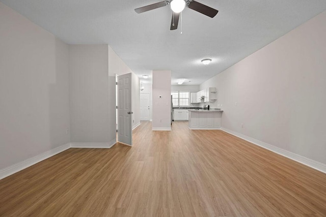 4591 Great Oak Dr, North Charleston, SC 29418 - unfurnished living room with a ceiling fan, baseboards, and light wood-type flooring