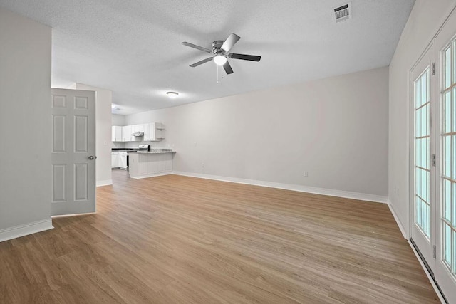 4591 Great Oak Dr, North Charleston, SC 29418 - unfurnished living room featuring ceiling fan, a textured ceiling, visible vents, baseboards, and light wood finished floors