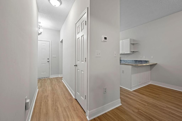 4591 Great Oak Dr, North Charleston, SC 29418 - hallway with a textured ceiling, baseboards, and light wood-style floors
