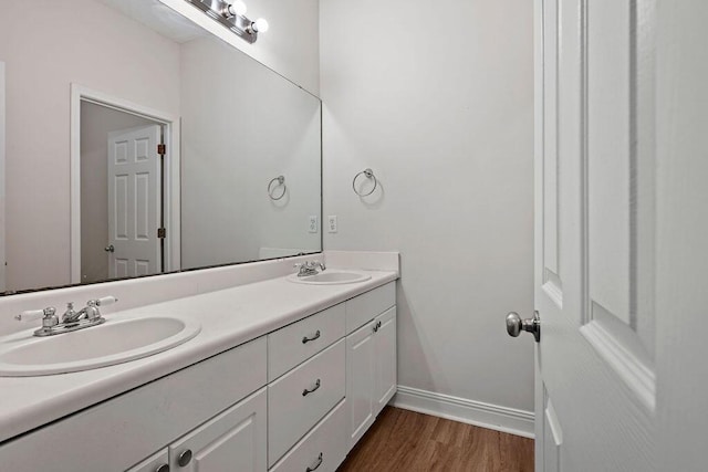 4591 Great Oak Dr, North Charleston, SC 29418 - bathroom featuring double vanity, baseboards, a sink, and wood finished floors