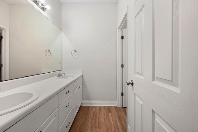 4591 Great Oak Dr, North Charleston, SC 29418 - full bath with baseboards, a sink, wood finished floors, and double vanity