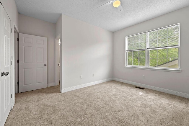 4591 Great Oak Dr, North Charleston, SC 29418 - unfurnished bedroom featuring baseboards, carpet, a textured ceiling, and visible vents