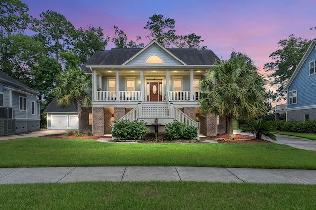 8605 Refuge Point Cir N, Charleston, SC 29420 - coastal home with concrete driveway, stairs, covered porch, a garage, and a front lawn
