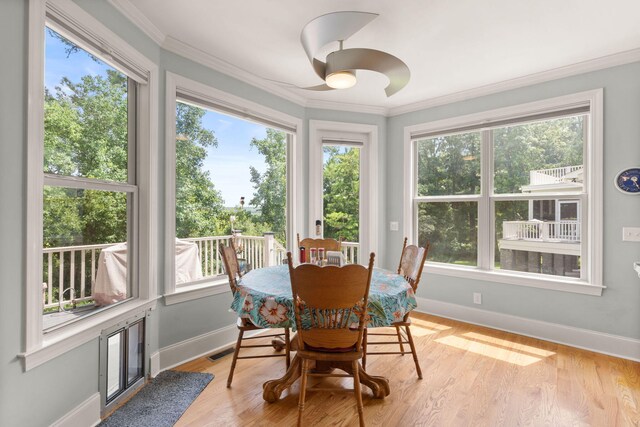 8605 Refuge Point Cir N, Charleston, SC 29420 - dining space with baseboards, crown molding, plenty of natural light, and light wood-style floors