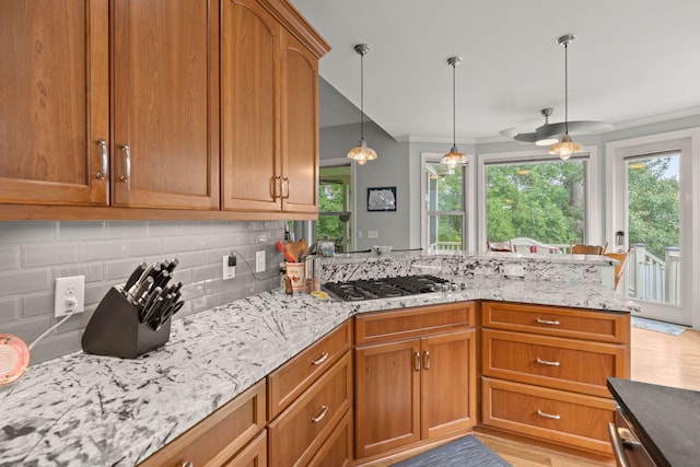 8605 Refuge Point Cir N, Charleston, SC 29420 - kitchen with ornamental molding, stainless steel gas stovetop, backsplash, healthy amount of natural light, and light stone counters