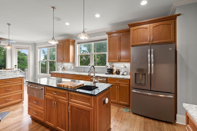 8605 Refuge Point Cir N, Charleston, SC 29420 - kitchen with stainless steel fridge, a warming drawer, ornamental molding, a sink, and a kitchen island with sink