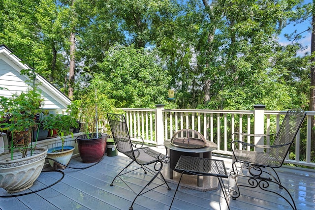 8605 Refuge Point Cir N, Charleston, SC 29420 - wooden deck with a fire pit and view of wooded area