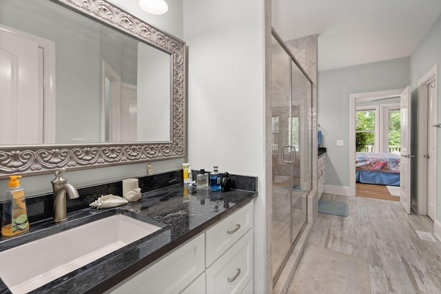 8605 Refuge Point Cir N, Charleston, SC 29420 - full bath featuring vanity, a stall shower, wood finished floors, and ensuite bath
