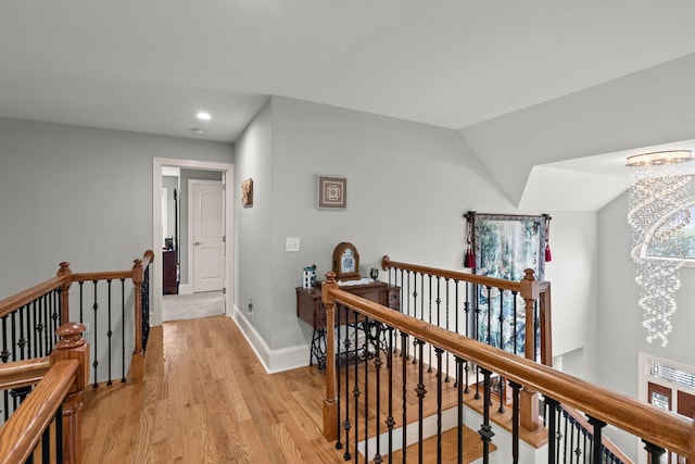 8605 Refuge Point Cir N, Charleston, SC 29420 - hallway with an upstairs landing, light wood finished floors, recessed lighting, baseboards, and a chandelier