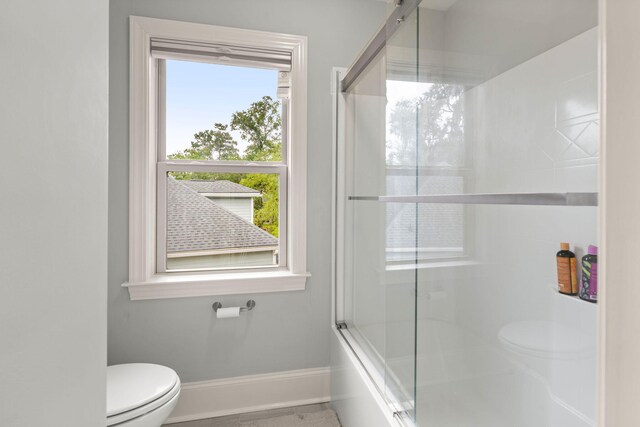 8605 Refuge Point Cir N, Charleston, SC 29420 - bathroom featuring toilet, baseboards, and shower / bath combination with glass door